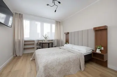 Łóżko lub łóżka w pokoju w obiekcie A Unique Studio with a Beautiful View of the Palace of Culture and Science by Noclegi Renters