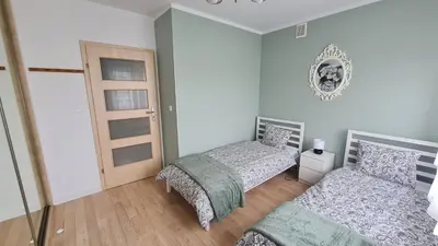 Łóżko lub łóżka w pokoju w obiekcie Apartament Leśny Ząbki