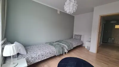 Łóżko lub łóżka w pokoju w obiekcie Apartament Leśny Ząbki