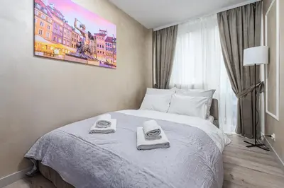 Łóżko lub łóżka w pokoju w obiekcie P&O Serviced Apartments Grzybowska 5