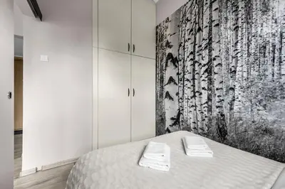 Łóżko lub łóżka w pokoju w obiekcie Żelazna Cozy Nest Apartment by BookingHost