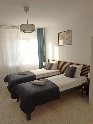 Łóżko lub łóżka w pokoju w obiekcie Laurens Apartment
