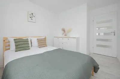 Łóżko lub łóżka w pokoju w obiekcie Smocza Bright & Cozy Apartment by Solarento