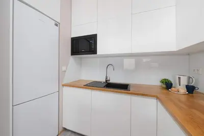 Kuchnia lub aneks kuchenny w obiekcie Cozy Apartment for 8 People with Air Conditioning and 2 Parking Spaces by Noclegi Renters