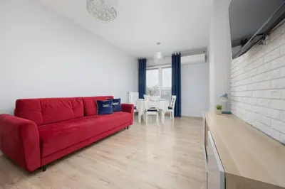 Część wypoczynkowa w obiekcie Cozy Apartment for 8 People with Air Conditioning and 2 Parking Spaces by Noclegi Renters