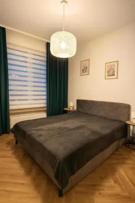 Łóżko lub łóżka w pokoju w obiekcie Apartamenty Jutrzenki