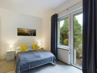 Łóżko lub łóżka w pokoju w obiekcie Nice Studio w Garden & Parking near Warsaw Airport