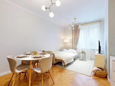 Łóżko lub łóżka w pokoju w obiekcie Moss Apartment Lazienki Park