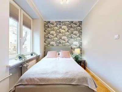 Łóżko lub łóżka w pokoju w obiekcie Moss Apartment Lazienki Park