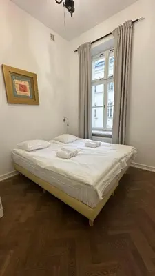 Łóżko lub łóżka w pokoju w obiekcie Kamienica Śródmieście Apartament 19A