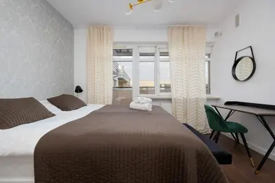 Łóżko lub łóżka w pokoju w obiekcie Avenue Chic Apartment Wilanowska by Solarento