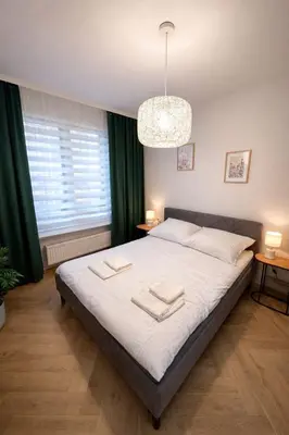 Łóżko lub łóżka w pokoju w obiekcie Apartament Jutrzenki