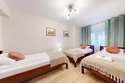Łóżko lub łóżka w pokoju w obiekcie Greenlight Apartment City Center Jana Pawla II
