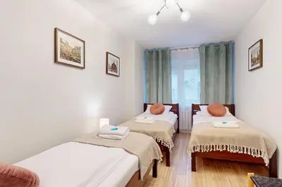 Łóżko lub łóżka w pokoju w obiekcie Greenlight Apartment City Center Jana Pawla II