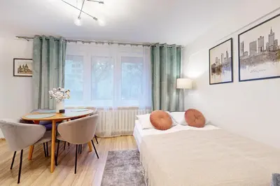 Łóżko lub łóżka w pokoju w obiekcie Greenlight Apartment City Center Jana Pawla II