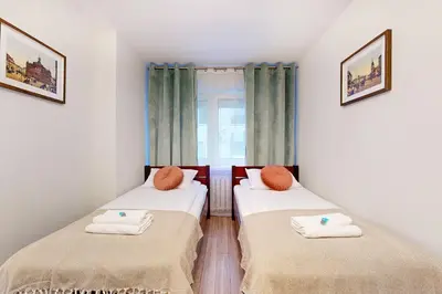 Łóżko lub łóżka w pokoju w obiekcie Greenlight Apartment City Center Jana Pawla II