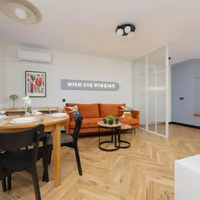 Blue and Orange Apartment with Desk in the Warsaw Center by Noclegi Renters