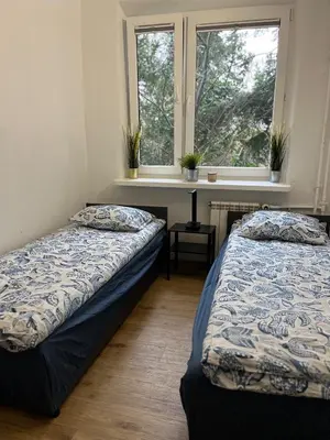 Łóżko lub łóżka w pokoju w obiekcie Pokoje Metro Imielin
