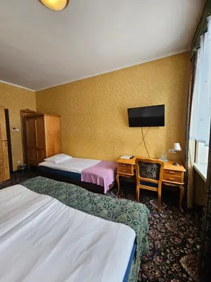 Łóżko lub łóżka w pokoju w obiekcie Folwark Historic Hotel