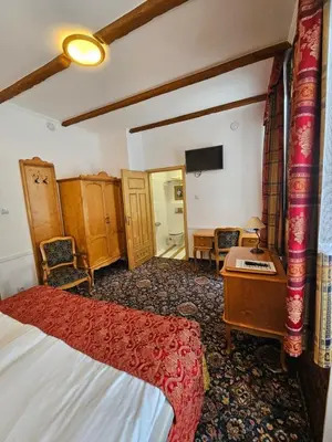 Łóżko lub łóżka w pokoju w obiekcie Folwark Historic Hotel