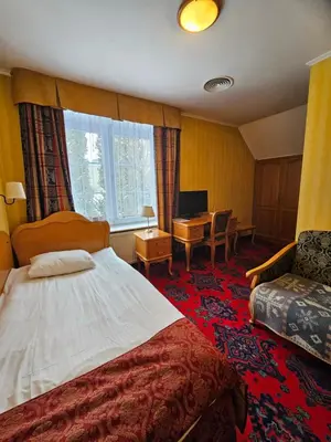 Łóżko lub łóżka w pokoju w obiekcie Folwark Historic Hotel