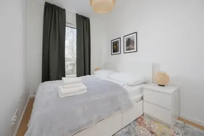 Łóżko lub łóżka w pokoju w obiekcie Green Apartments Bora-Komorowskiego by Solarento