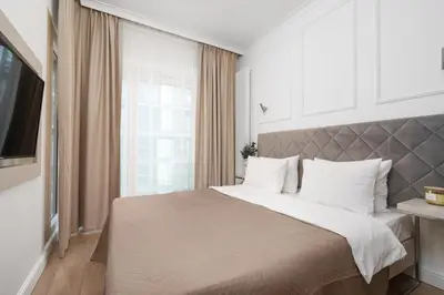 Łóżko lub łóżka w pokoju w obiekcie Mennica Residence Aparthotel