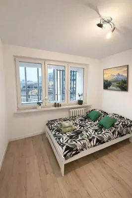 Łóżko lub łóżka w pokoju w obiekcie Chmielna Residence