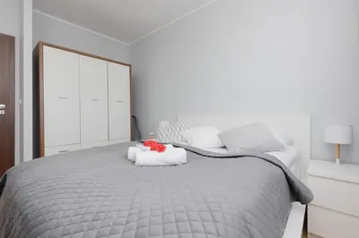 Łóżko lub łóżka w pokoju w obiekcie Unique Apartment with Balcony in Warsaw by Noclegi Renters