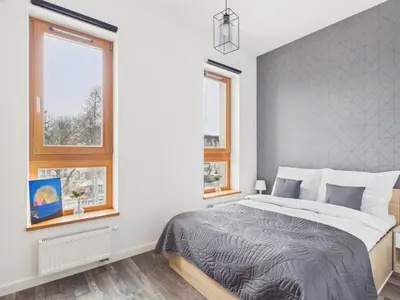 Łóżko lub łóżka w pokoju w obiekcie Popularna 38 Comfort Suite Warsaw by Solarento