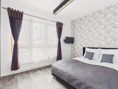 Łóżko lub łóżka w pokoju w obiekcie Popularna 38 Comfort Suite Warsaw by Solarento