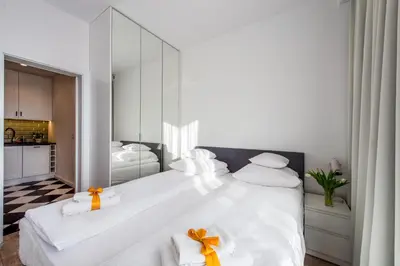 Łóżko lub łóżka w pokoju w obiekcie GO Apartments - ApartHotel