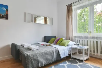 Łóżko lub łóżka w pokoju w obiekcie P&O Apartments Plac Zbawiciela