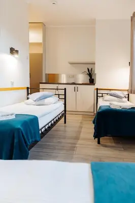 Łóżko lub łóżka w pokoju w obiekcie Arcus Premium Hostel