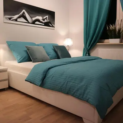 Łóżko lub łóżka w pokoju w obiekcie Apartamenty Nad Jeziorkiem