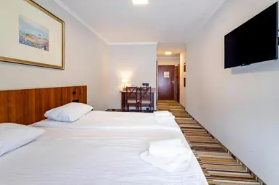 Łóżko lub łóżka w pokoju w obiekcie Hit Hotel
