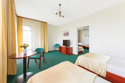 Łóżko lub łóżka w pokoju w obiekcie Hotel Arkadia