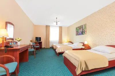 Łóżko lub łóżka w pokoju w obiekcie Hotel Arkadia