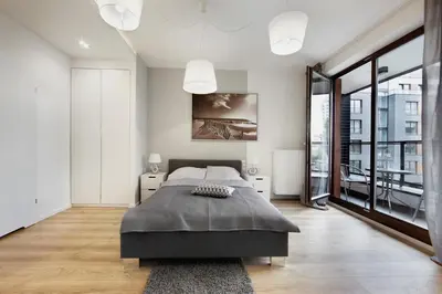 Łóżko lub łóżka w pokoju w obiekcie SilverApartments