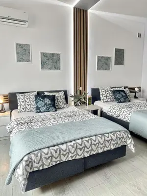 Łóżko lub łóżka w pokoju w obiekcie Exclusive Apartments Smolna