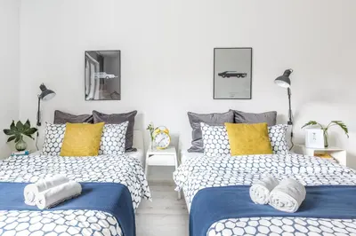 Łóżko lub łóżka w pokoju w obiekcie Palm Aparts Warsaw