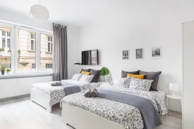Łóżko lub łóżka w pokoju w obiekcie Palm Aparts Warsaw