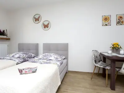 Łóżko lub łóżka w pokoju w obiekcie Manhattan Place Apartament