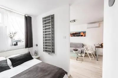 Łóżko lub łóżka w pokoju w obiekcie Alma Apartments Grzybowska