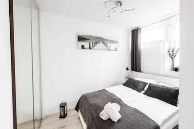 Łóżko lub łóżka w pokoju w obiekcie Alma Apartments Grzybowska