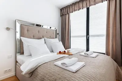 Łóżko lub łóżka w pokoju w obiekcie P&O Apartments Aleja Krakowska
