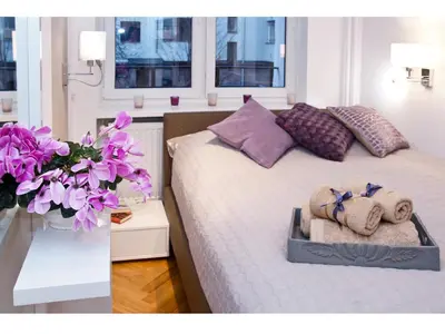 Łóżko lub łóżka w pokoju w obiekcie Srebrna Warsaw Apartment