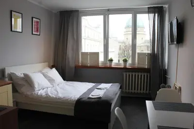 Łóżko lub łóżka w pokoju w obiekcie Noctis Apartment Nowogrodzka