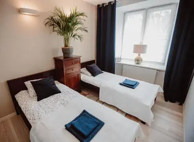 Łóżko lub łóżka w pokoju w obiekcie Apartament Wisniowa