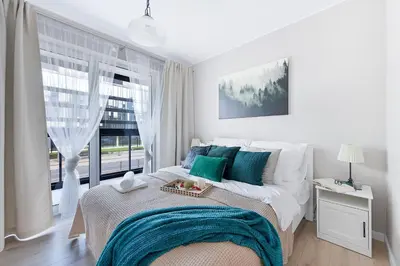Łóżko lub łóżka w pokoju w obiekcie P&O Corporate Serviced Apartments Cybernetyki